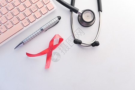 红丝带HIV 以及白色背景的听诊器黑色庆典机构红色丝带卷曲癌症治愈活动图片