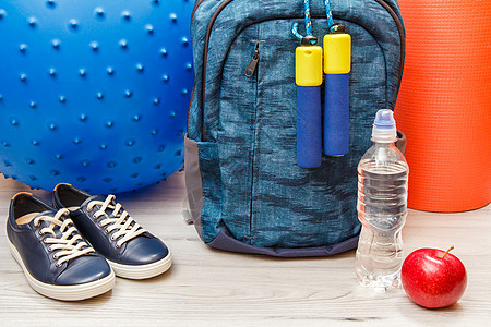 会议室地板健身用的各种背包和不同工具瓶子体操运动训练蓝色运动员白色力量重量运动鞋图片