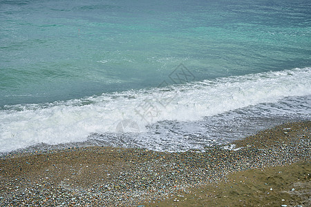 海滨 海边有碎石 沙滩上湿海岩和宁静的海浪海岸戏剧性热带飞溅海洋海岸线天气海滩旅行冲击波图片