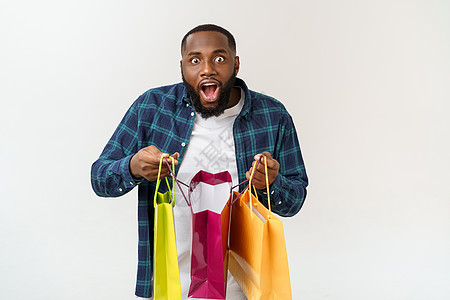 非洲快乐的美国人在白色背景上拿着购物袋 享受节日概念女性可用购物者回收男人爆炸亚麻空间男性标识图片