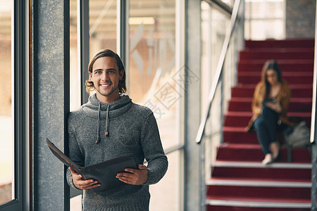 我对即将到来的决赛充满信心 一位英俊年轻大学生在校园走廊里学习的肖像被剪裁成画面了 他当时正站在走廊上图片