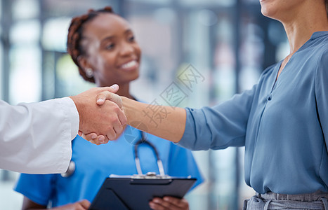 医生握手谢谢你 问候或良好的医学突破成功与背景中微笑的护士 医生 医护人员和患者为健康研究的创新握手图片