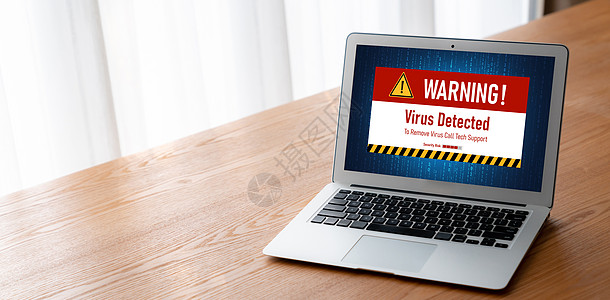 计算机屏幕上的病毒警报警报 检测到网络威胁的变异安全电脑药片职场展示软件男人颅骨商业桌子图片