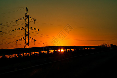 日落时电塔 电压高架车站电气活力电缆工程力量技术危险电力塔金属图片
