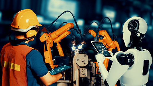 网络化工业机器人和工人在未来工厂中共同工作的人类工人以及人工智能制造业电脑自动化手臂合伙生产合作作坊伙伴图片