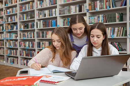 在图书馆一起学习的年少少女女孩桌子创造力考试幸福互联网智力文学校园教育笔记本图片