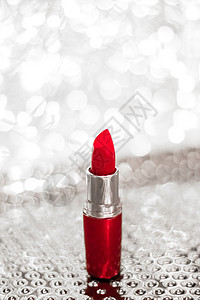银色圣诞节 新年和情人节假期闪光背景上的红色唇膏 奢侈美容品牌的化妆品和化妆品美丽礼物口红光泽度玫瑰产品季节销售生物金子图片
