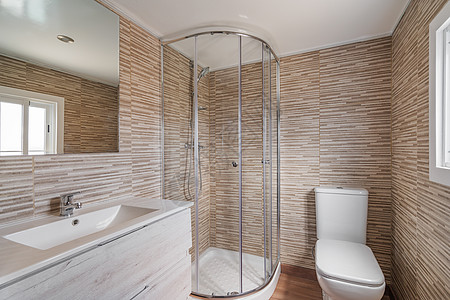 浴室简便 有淋浴房 白马桶 木家具和米砖 装修后的公寓内部图片