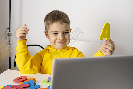 可爱 可爱的小男孩在线学习字母表 家里有笔记本电脑 孩子使用电子学习平台与老师进行视频通话并学习 儿童在家上学和远程教育互联网家图片