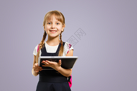 微笑积极活跃的优秀最佳女学生 女孩拿着书和上学时穿着包袋教育遥控器儿童课程学习小学生工作室科目工作校友图片