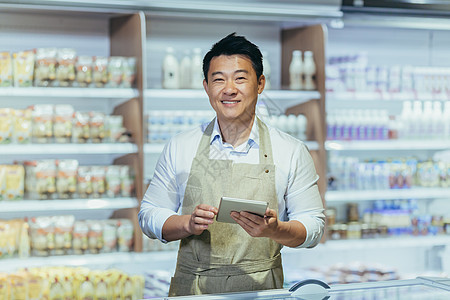 一个年轻的英俊亚洲男子的肖像 店主 超市工人图片