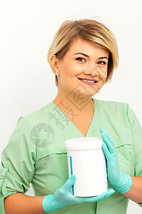 化妆品奶油和护肤产品在美容女性的手中微笑 站在白墙背景上站着 笑声脱毛治疗程序药品护理诊所胶原女士皮肤皮肤科图片