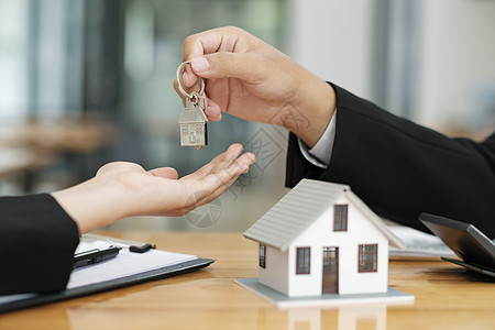房地产代理商在签署合同后向客户提供房屋钥匙信用顾客代理人商业谈判财产销售金融生意投资图片