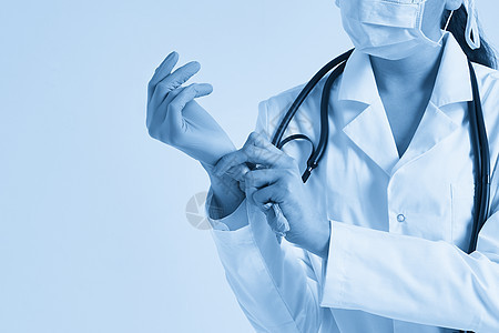 年轻医生在白色背景上戴上外科手套的年轻医生卫生实习生调子安全蓝色感染面具手臂护士从业者图片