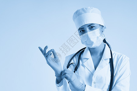 年轻医生在白色背景上戴上外科手套的年轻医生卫生调子健康女士考试蓝色橡皮安全手臂医师图片