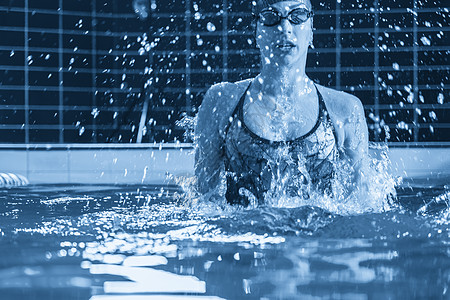 年轻专业游泳运动员在室内游泳池游泳 喷水量很大飞溅游泳衣运动女孩活动女士行动假期调色游泳者图片