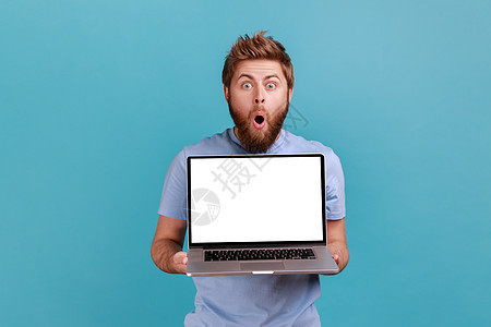 男人用空白显示笔记本电脑 做广告的地方 用大眼睛看照相机图片