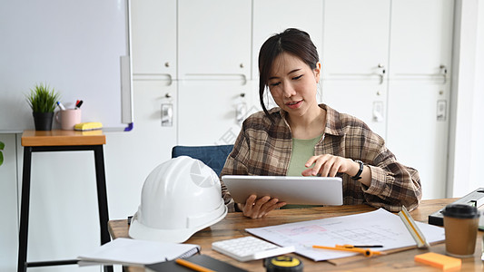 女建筑工程师在工作场所使用数字平板电脑工作 (单位 千分之一)图片