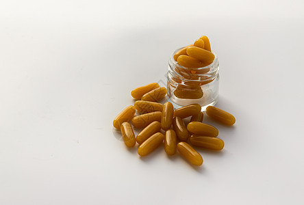 白底玻璃瓶里有金油胶囊食物药品治疗药瓶团体治愈养分胶囊营养饮食图片