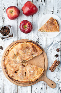 带新鲜红苹果的自制苹果派桌子盘子肉桂烹饪季节糕点蛋糕高架水果食物图片