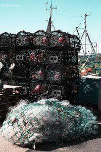 在港口码头 近身底底底鱼网和渔船上堆叠的渔网海洋海岸漂浮食物细绳齿轮蓝色钓鱼海鲜尼龙图片