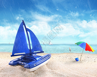 玩具帆船在沙滩的沙滩上图片