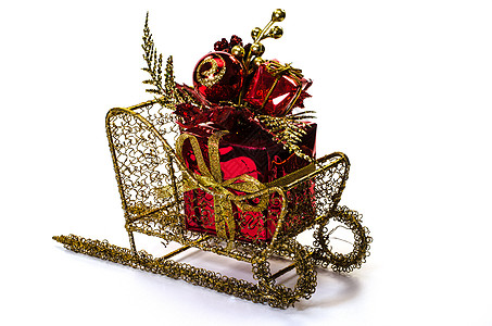 圣诞礼物在雪橇上 金子 假期 十二月 白色的背景图片