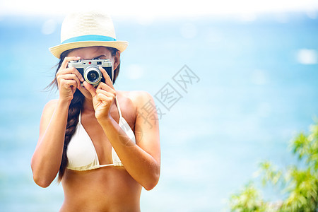 夏夏沙滩女人拿着照相机拍照图片