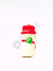 圣诞雪娃娃蜡烛的侧边 白背景上孤立图片