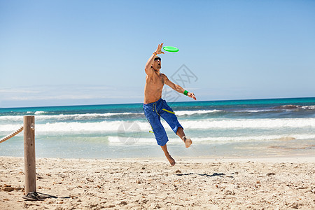 夏天在海滩上玩游骑球的有魅力的男人 海洋 跑步高清图片