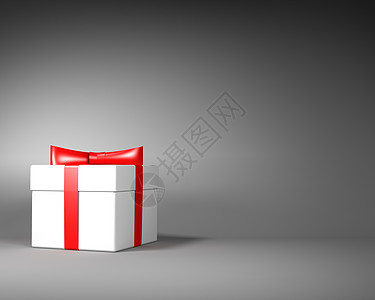 白色礼物盒 带红丝带和弓在灰色背景上图片