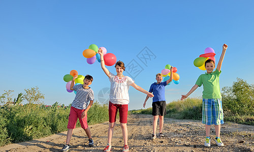 带着多彩气球的快乐儿童 场地 草 户外 手 孩子们图片