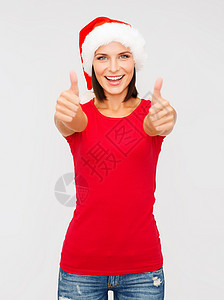 穿着圣塔女助手帽子的女士举起大拇指 美丽 十二月图片