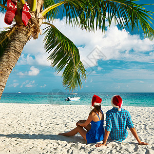 在圣诞节海滩上穿蓝衣服的情侣 棕褐色 家庭 女士图片