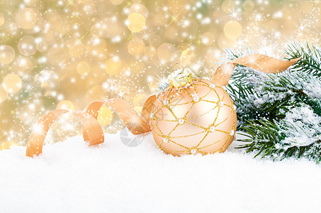 金色圣诞节装饰球 在抽象的ba 上带丝结弓图片