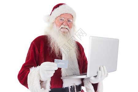 圣诞老人用笔记本电脑支付信用卡 打字 胡须 化装舞会服装背景图片