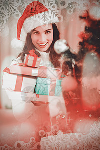 喜庆黑发在圣诞树附近藏着一堆礼物的复合图象 丝带 快乐图片