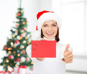 戴着红卡空白的圣塔帮手帽的妇女 圣诞老人 快乐的 折扣图片