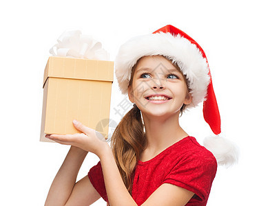 带着礼物盒的圣塔帮手帽子中的笑笑女孩 美丽的图片