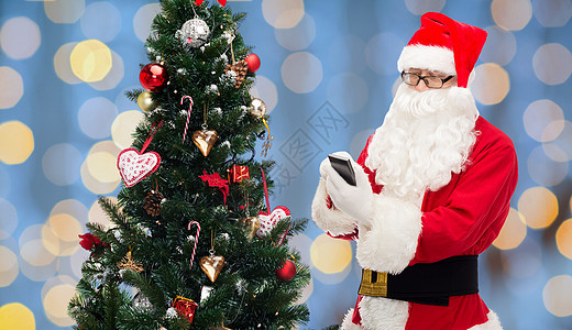 带智能手机和圣诞树的 胡须 无线上网 小工具 快乐 细胞图片