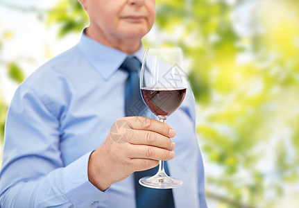 紧近的老人 拿着杯子和红酒 退休 衬衫 领带图片