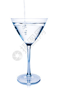 白鸡尾酒装满了蓝色反光的玻璃杯图片
