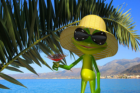 绿青蛙在海滩上与玻璃杯图片