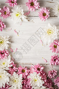 白色木制桌垂直的粉红花和白花边框背景图片