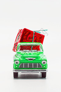 带一个孤立的红色礼品箱的绿色旧车小卡车 庆典图片