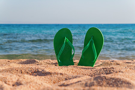 海边沙滩上的绿色翻滚 闲暇 蓝色的 时尚 鞋类 旅行图片