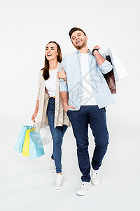 快乐的年轻夫妇穿着白色袋装购物袋行走的全部画面 男朋友 团聚图片