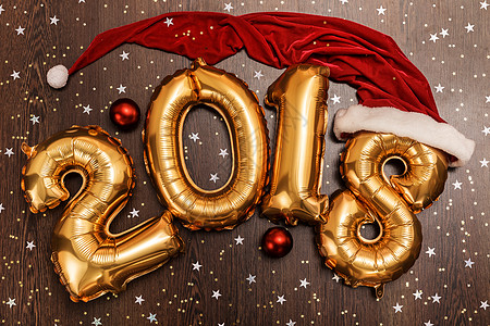 2018年 圣诞节 新年气球 黑色木质桌底有闪亮星的亮金金色气球 金属的图片