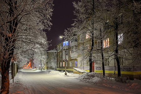 晚上街道上有雪树 灯光照亮 房屋窗户用不同颜色漆成 笑声 图片