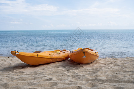 沙滩上的两艘彩色橙色皮划艇在阳光明媚的日子里为桨手做好准备 在沙子的几艘橙色消遣小船 活跃的旅游和水上娱乐 旅行 乐趣图片